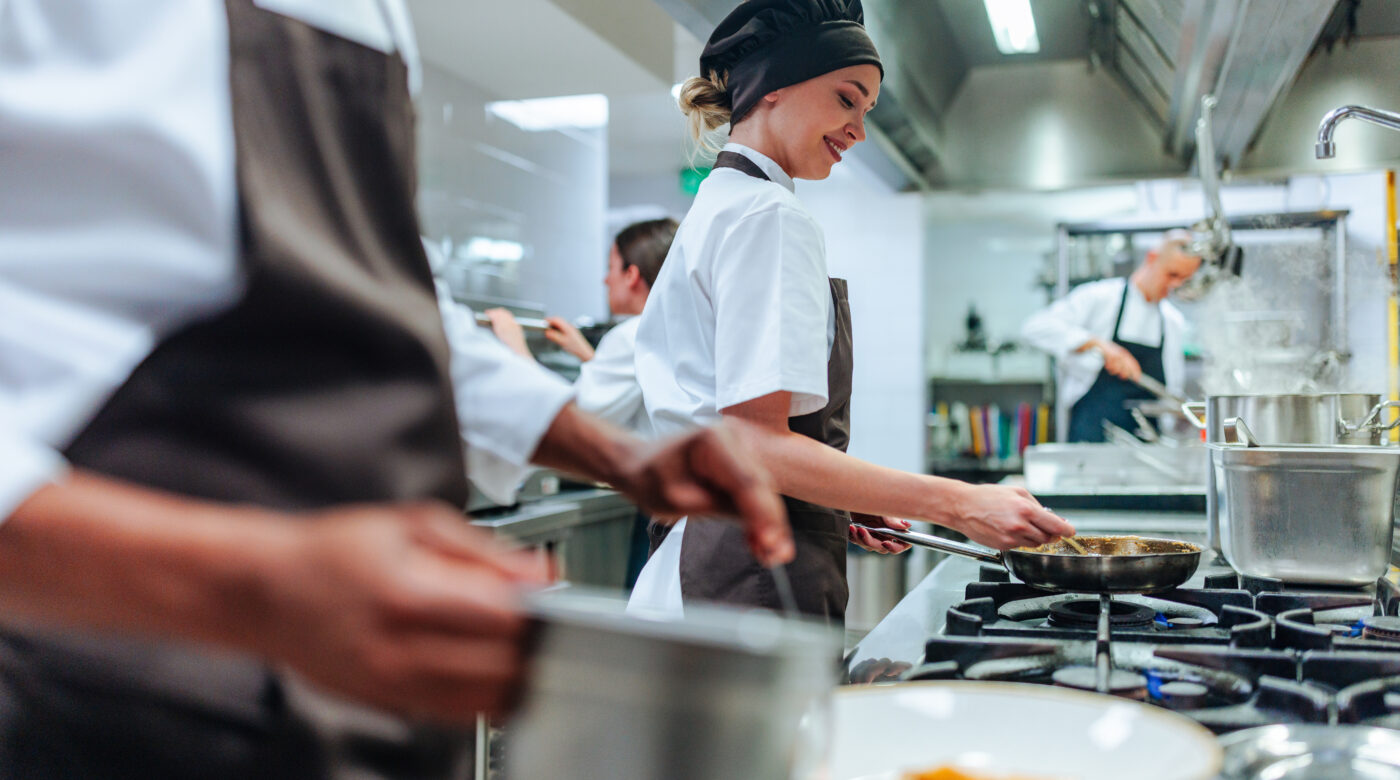 Professional Cooking Team Working In Kitchen
