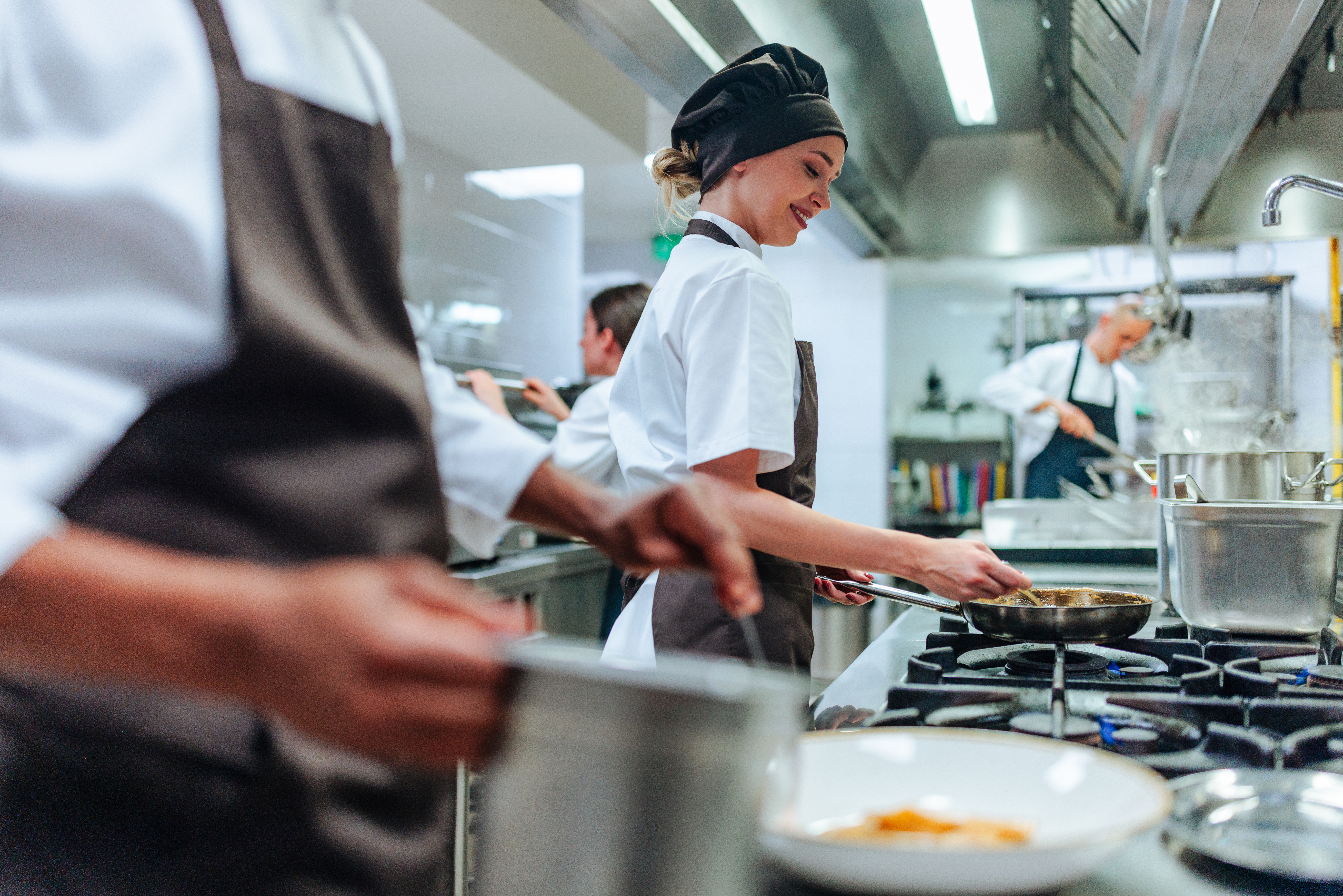 Professional Cooking Team Working In Kitchen