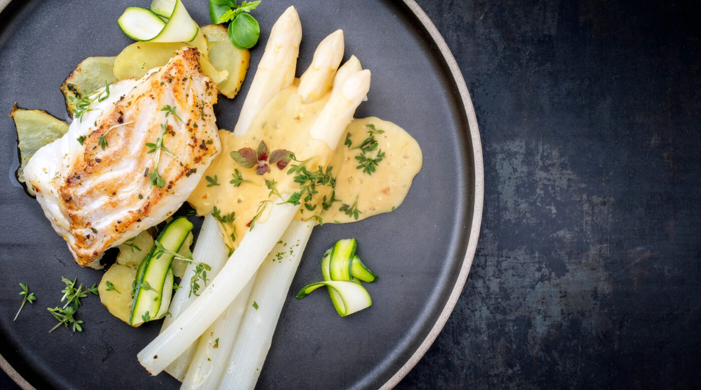 Modern Style German Fried Cod Fish Filet With White Asparagus In