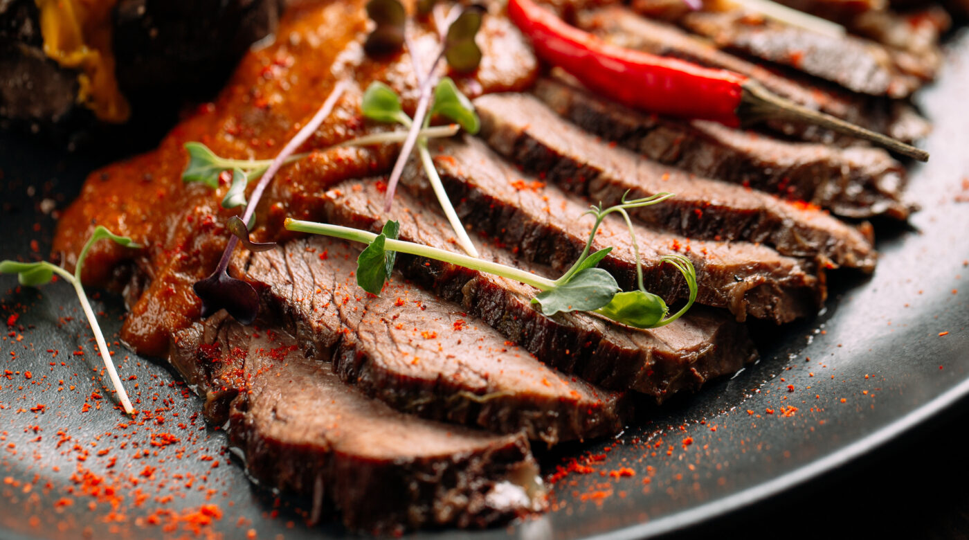 Sliced Roasted Beef With Sauce And Greens