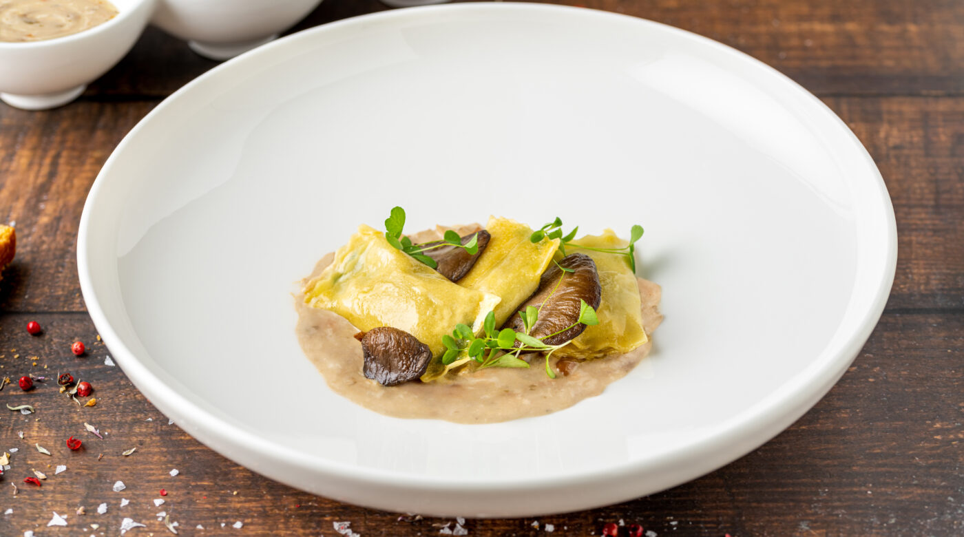 Mushroom Ravioli In White Porcelain Plate On Wooden Table