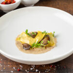 Mushroom Ravioli In White Porcelain Plate On Wooden Table