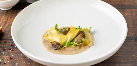 Mushroom Ravioli In White Porcelain Plate On Wooden Table